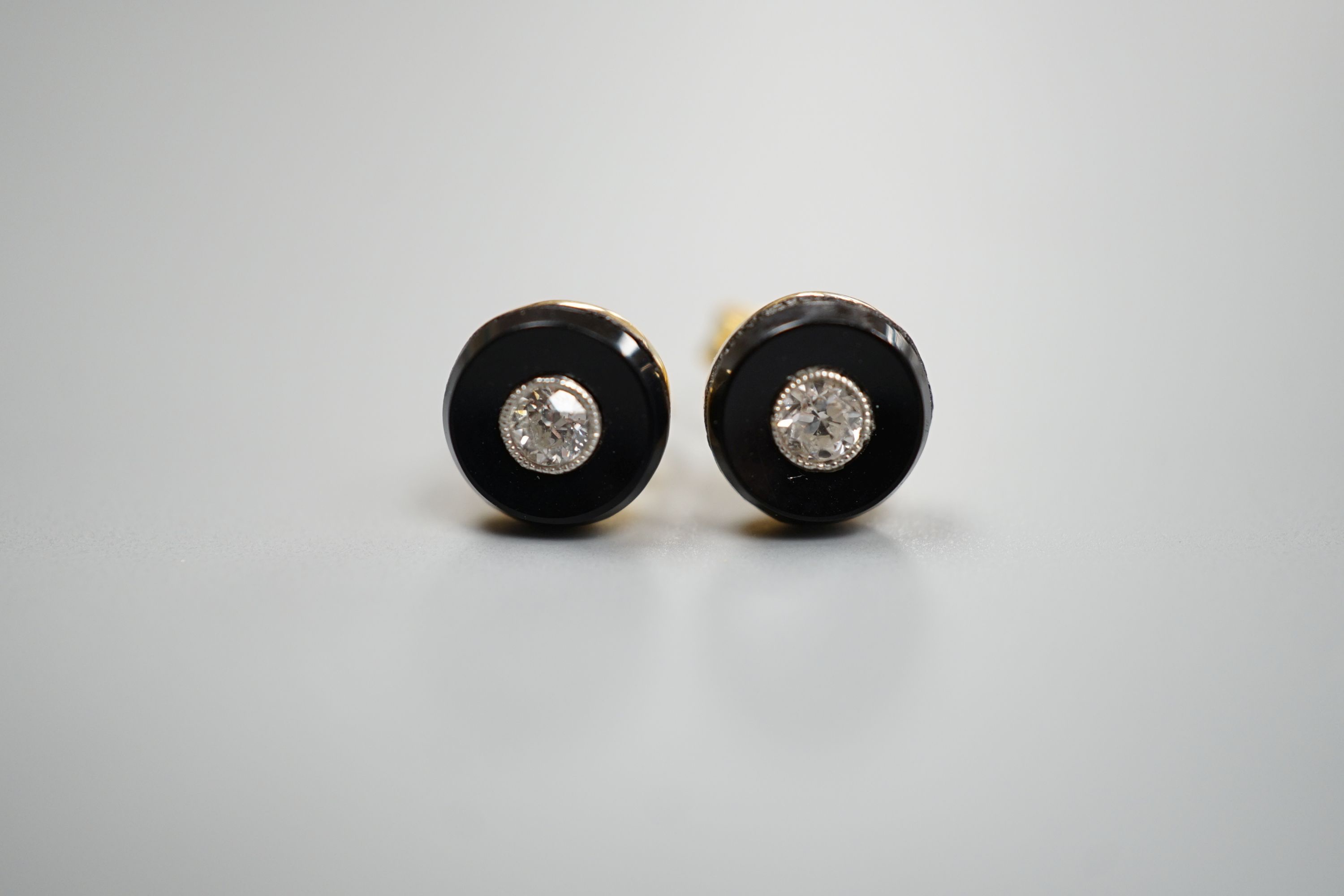A pair of 750 yellow metal, black onyx and diamond set circular ear studs, 6mm, gross weight 1.8 grams.
